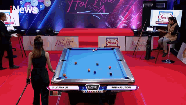 a pool table with silviana lu and rini nasution on the scoreboard
