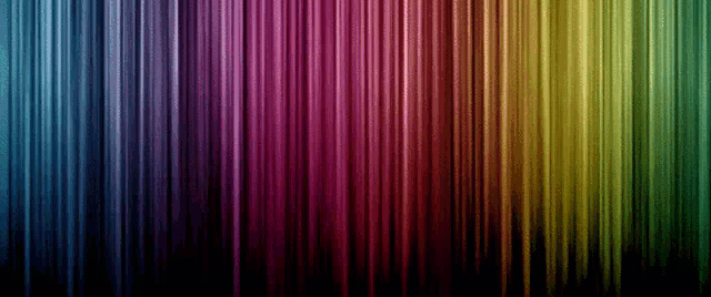 a rainbow of colors is displayed on a dark background
