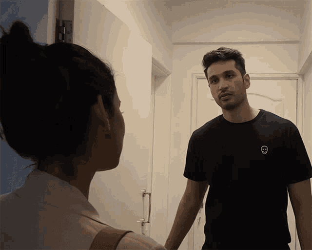 a man in a black shirt with a skull on it