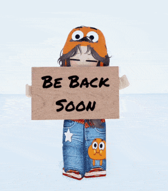a person holding a wooden sign that says be back soon