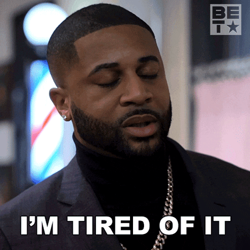 a man in a suit says i 'm tired of it with his eyes closed