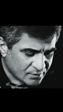 a close up of a man 's face in a black and white photo .