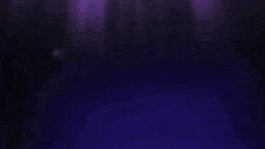 a person making a heart shape with their hands in the dark