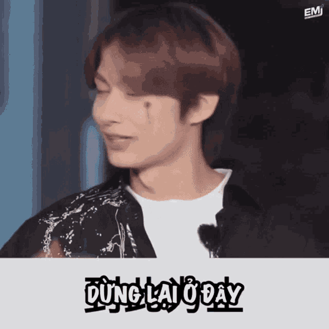 a man with a tear coming out of his eye and the words dung lai o day