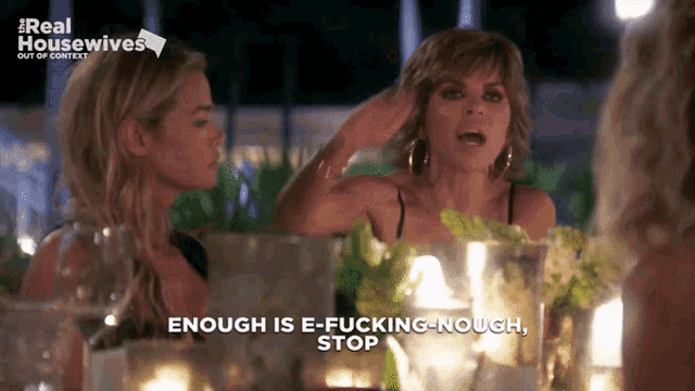 two women sitting at a table with the words " enough is e-fucking-nought stop " on the bottom