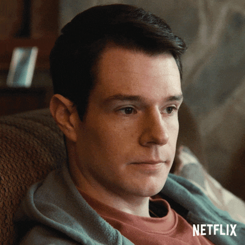 a man is sitting in a chair with a netflix logo on the bottom
