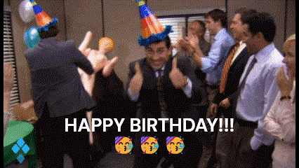 a group of people are celebrating a birthday with a man wearing a party hat