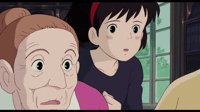 a little girl and an older woman are looking at something