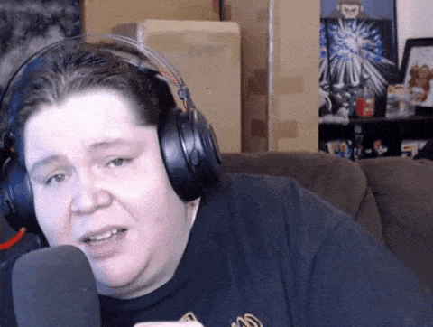a man wearing headphones is talking into a microphone in a living room