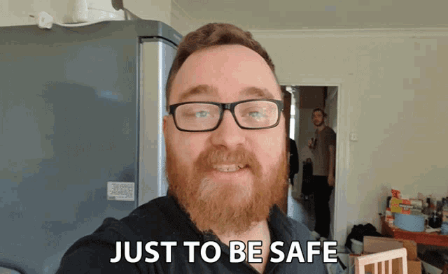 a man with glasses and a beard has just to be safe written on his face