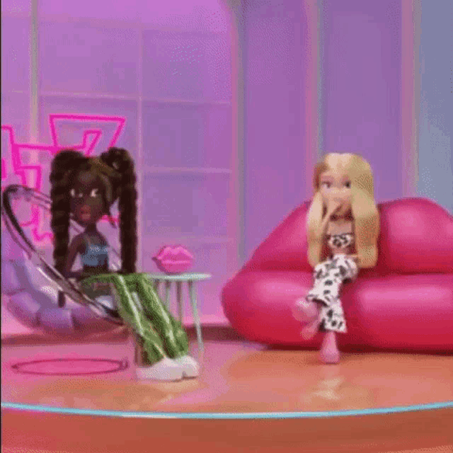 two dolls are sitting next to each other on a stage .