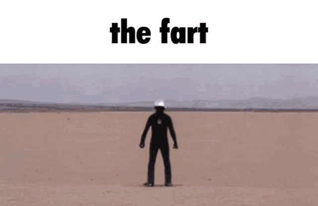 a man is riding a motorcycle in the desert with the words `` the fart '' written on the bottom .