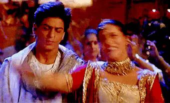 a man and a woman are dancing in front of a crowd of people