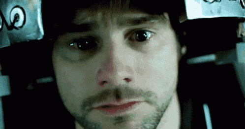 a close up of a man 's face with a helmet on