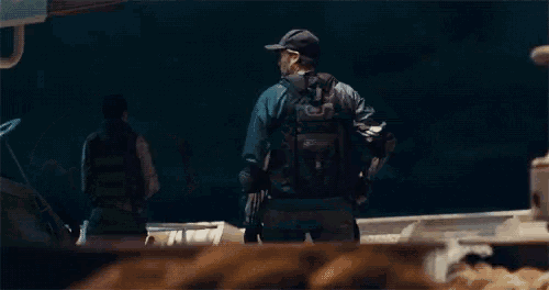 a man in a captain america costume is holding a shield in his hands .