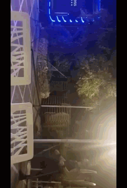 a person is sitting at a table in front of a building at night