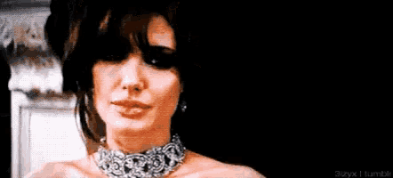 a woman wearing a choker is making a funny face .