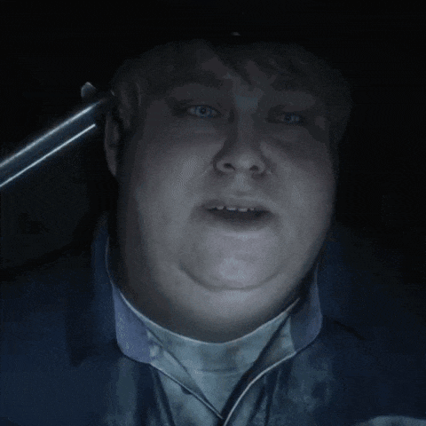 a close up of a man 's face in a dark room with his mouth open