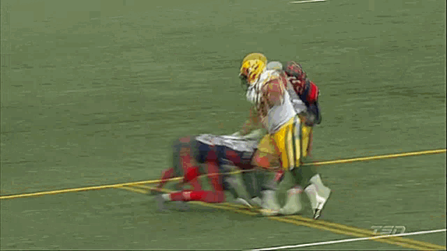 a football player with the number 36 on his jersey is being tackled