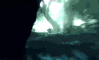 a blurred image of a person standing in the dark