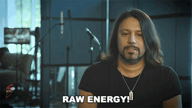 a man with long hair and a beard says " raw energy "