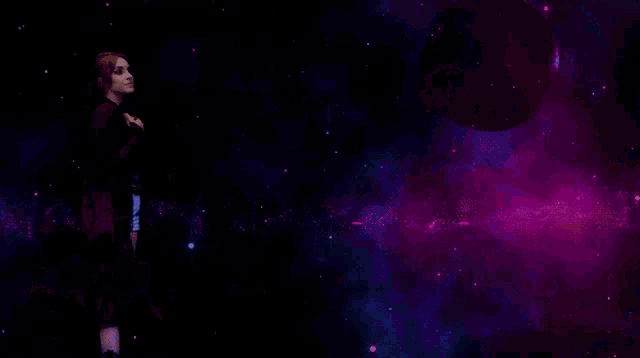 a woman is standing in a dark room with purple lights