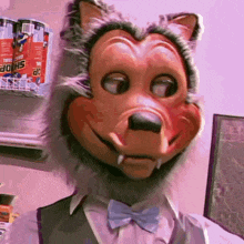 a man wearing a wolf mask and bow tie