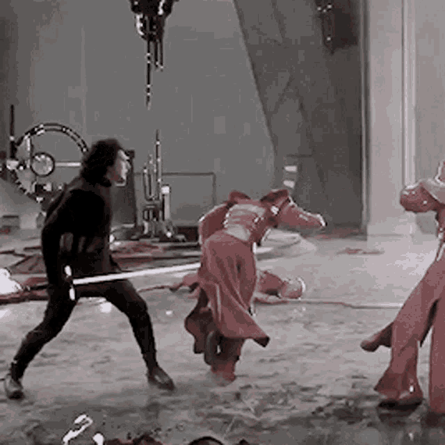 a man holding a sword is fighting another man in a red robe