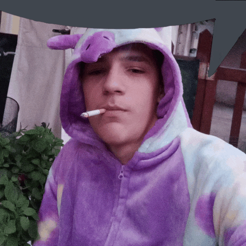 a man wearing a purple and blue unicorn costume smoking a cigarette