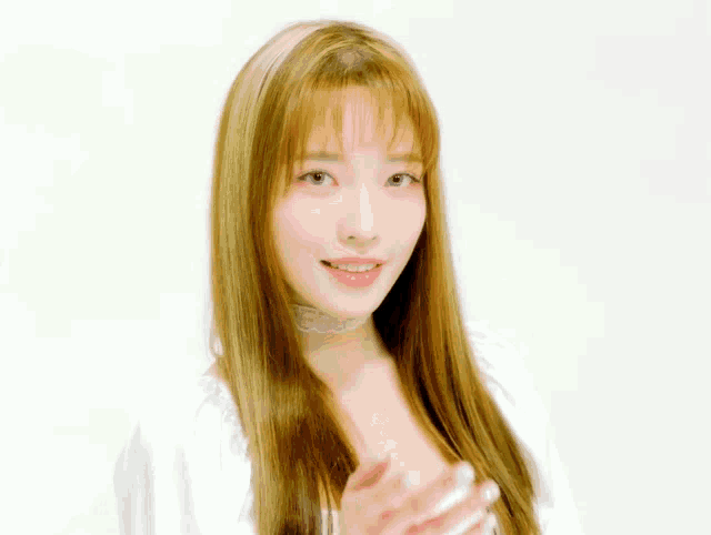 a woman with long hair and bangs is wearing a choker and a white shirt