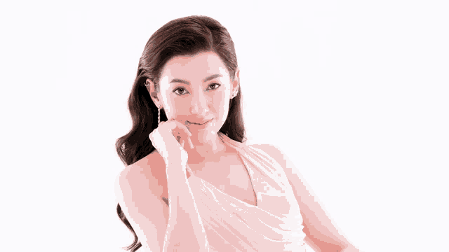 a woman in a pink dress with her hand on her face