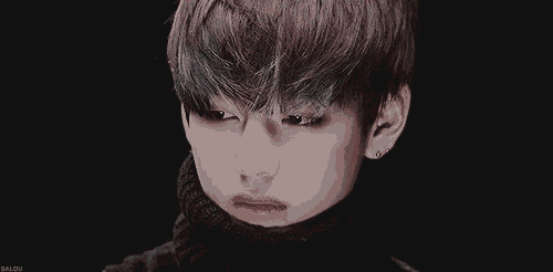 a close up of a person 's face with a black background that says galou on the bottom