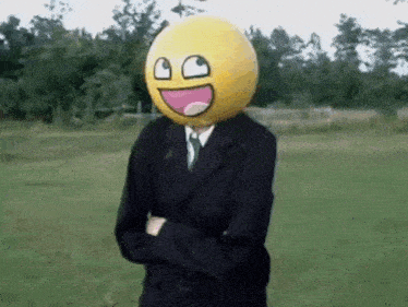 a man in a suit is wearing a smiley face on his head .