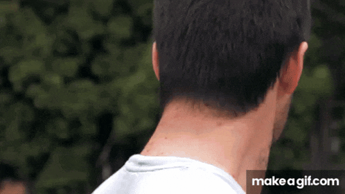 the back of a man 's neck is shown in a make a gif.com gif