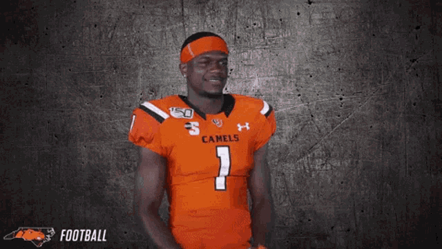 a football player wearing an orange jersey with the number 7 on it