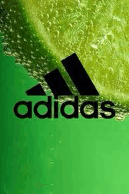 the adidas logo is on a green background with a slice of lime in the background .