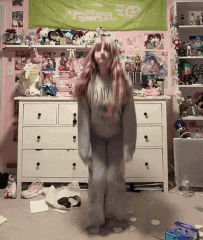 a girl stands in front of a dresser and a green banner that says disney