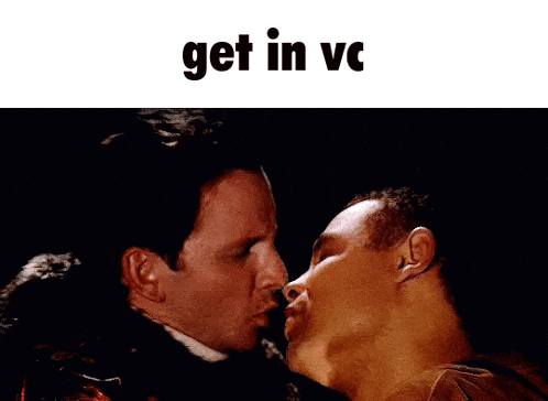a couple of men kissing with the words get in vc above them