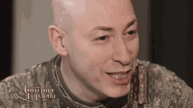 a close up of a man 's face with the name dimitria gordona on the bottom right