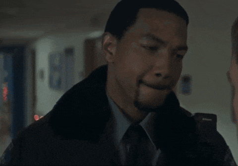 a man in a suit and tie is standing in a hallway