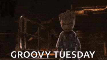 groot from guardians of the galaxy 2 is standing in a room with the words groovy tuesday written on the bottom .