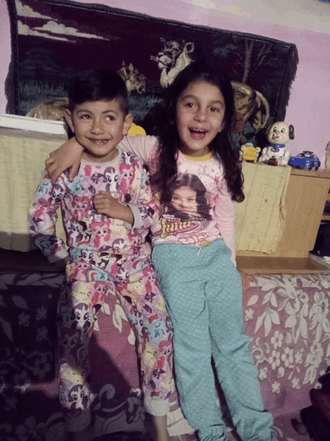 a boy and a girl are posing for a picture and the girl is wearing a shirt that says julia