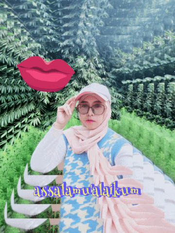 a woman wearing glasses and a hijab stands in front of a green background with the words " assalamualaikum " on it