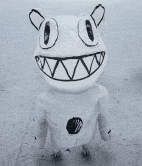 a stuffed animal with a drawing of a cat on its head