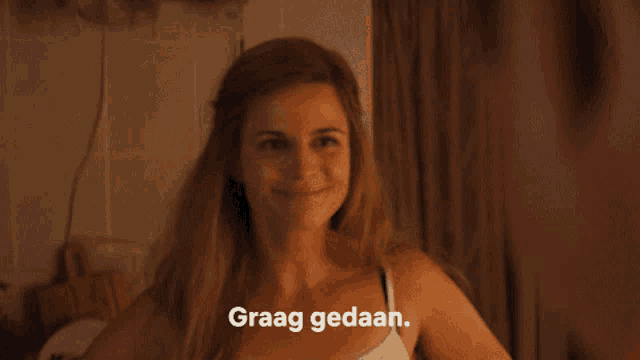 a woman in a white tank top is smiling and the words graag gedaan are above her