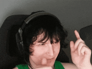a young man wearing headphones and a green tank top