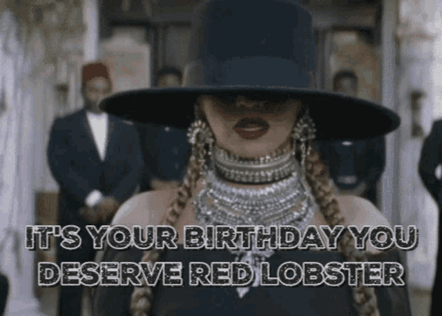 a woman wearing a black hat and a necklace says it 's your birthday you deserve red lobster
