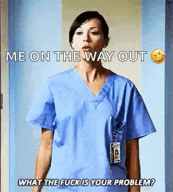 a nurse in a blue scrub is standing in a doorway .
