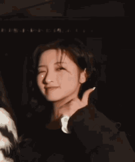 a woman giving a thumbs up while another woman looks on