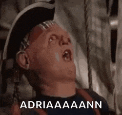 a man is wearing a pirate hat and making a funny face with his mouth open .